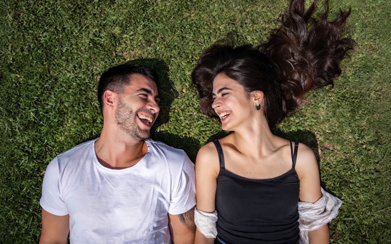 Couple lying in grass